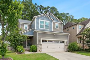 Apex house for rent - A two-story house with a garage and a driveway.