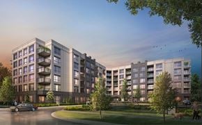 Whitby apartment for rent - A modern apartment complex with a car driving on the street in front.