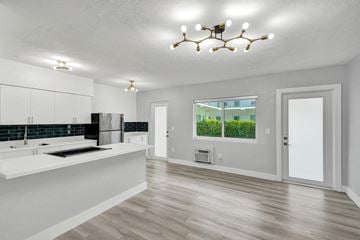 Bay Harbor apartment for rent - A modern kitchen with white cabinets and a large island.