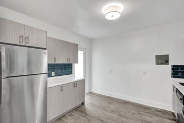 Bay Harbor apartment for rent - A kitchen with a stainless steel refrigerator and wooden cabinets.