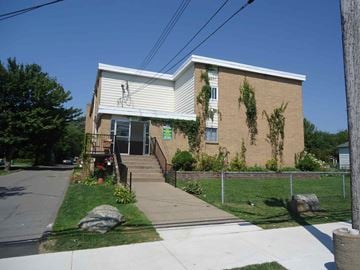 Dartmouth apartment for rent - A small building with a white roof and a fence in front.