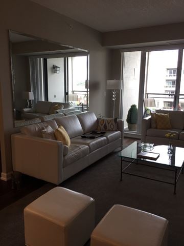 Oshawa apartment for rent - A living room with a grey couch and a glass coffee table.