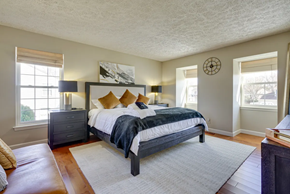 Lumberton Township house for rent - A bedroom with a large bed and a window.