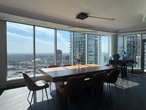 Calgary apartment for rent - A conference room with a long table and chairs with a view of the city.