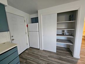 Nampa apartment for rent - A kitchen with a white fridge and a white door.