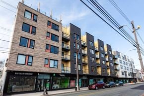 Halifax apartment for rent - A street view of a multi-story building with a barbershop on the ground floor.