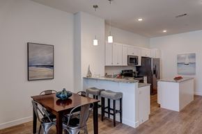East Providence apartment for rent - A kitchen with a table and chairs in front of it.