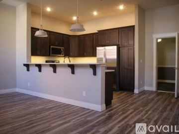 Casper apartment for rent - A kitchen with brown cabinets and a white counter.