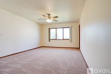 Coralville house for rent - A kitchen with wooden cabinets and white appliances.