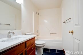 Coralville house for rent - A spacious living room with a fireplace and sliding glass doors.