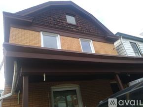 Pittsburgh house for rent - A house with a brown roof and a white window.