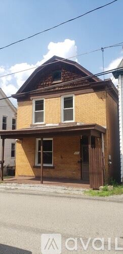 Pittsburgh house for rent - A house with a brown roof and a brick exterior is shown.