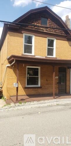 Pittsburgh house for rent - A house with a brown roof and a white window.