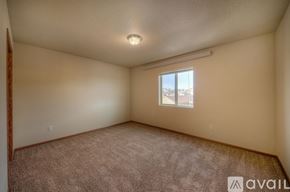 Rapid City apartment for rent - A room with a window and carpeted floor.