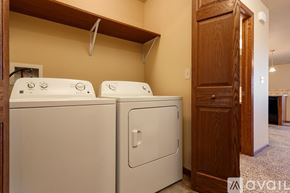 Summerset apartment for rent - Two white front loading washing machines in a laundry room.