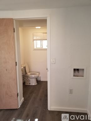 Pueblo house for rent - A bathroom with a toilet and a window.