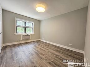 Chicago apartment for rent - A room with a window and a wooden floor.