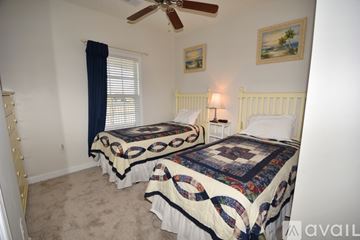 North Myrtle Beach apartment for rent - A bedroom with two beds and a ceiling fan.