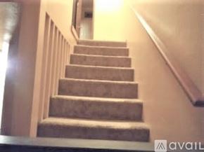 Lynnwood apartment for rent - A staircase with a carpeted runner and wooden handrail.