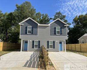 Fayetteville house for rent - A two-story house with a grey exterior and a blue door.