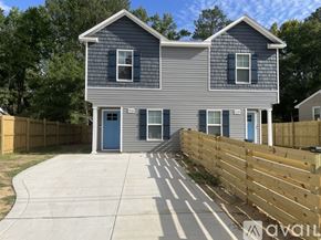 Fayetteville house for rent - A grey house with a blue door and windows.