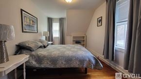Ogunquit house for rent - A bedroom with a bed, nightstand, and window.