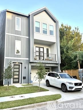 Houston house for rent - A modern two-story house with a blue exterior and white trim.