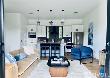 Houston house for rent - A living room with a grey sofa and a white counter.
