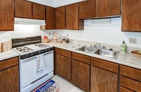 Indianapolis apartment for rent - Kitchen with white appliances and plenty of cabinetry for food and kitchen utensil storage