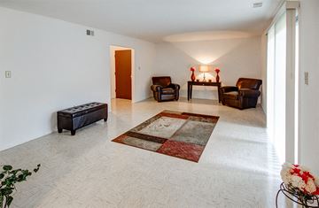 Indianapolis apartment for rent - A living room with a rug and three chairs.