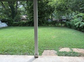 Murfreesboro house for rent - A grassy area with a pole in the foreground.