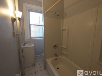 Baltimore apartment for rent - A kitchen with a stove, sink, and window.