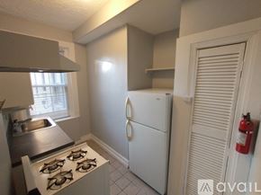 Baltimore apartment for rent - A room with a white door and wooden floors.