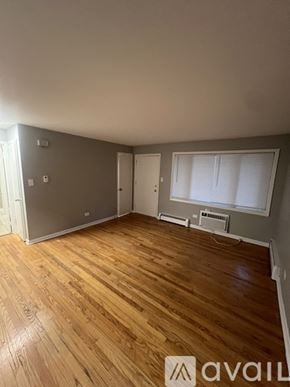 Worth apartment for rent - A room with wooden flooring and a refrigerator in the corner.