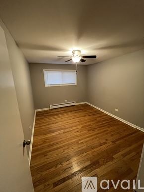 Worth apartment for rent - A kitchen with white appliances and brown cabinets.