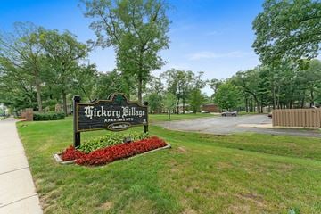 Muskegon apartment for rent - A sign for Thickory Village Apartments is in front of a grassy area.