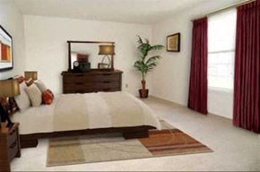 Toledo apartment for rent - a bedroom with a bed and a potted plant