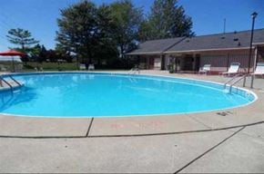 Toledo apartment for rent - a large swimming pool in front of a house