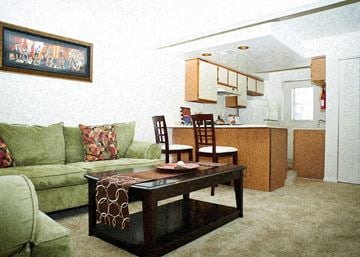 Indianapolis apartment for rent - A living room with a green couch and a coffee table.