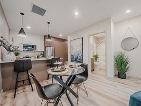 Edmonton apartment for rent - A modern kitchen with a dining table and chairs.