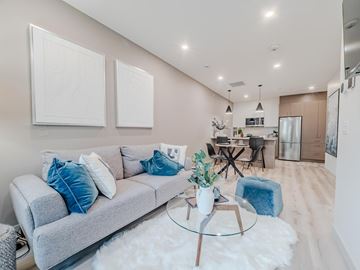 Edmonton apartment for rent - A modern living room with a grey sofa and a glass coffee table.