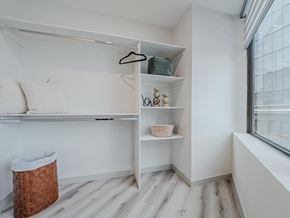 Edmonton apartment for rent - A room with a white wall and a window with a view of a building outside.