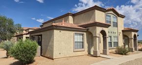 Sierra Vista apartment for rent - A house with a red tile roof and a brown stucco exterior.