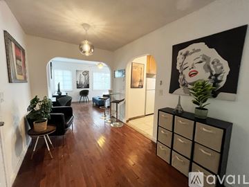 Miami apartment for rent - A living room with a wooden floor and a large painting of Marilyn Monroe on the wall.
