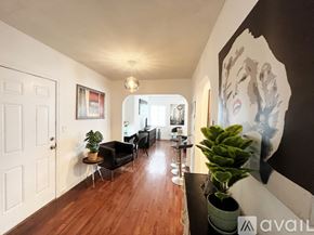 Miami apartment for rent - A living room with a couch, chairs, and a potted plant.