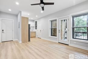 Chicago apartment for rent - A spacious room with a ceiling fan and lighting fixtures.