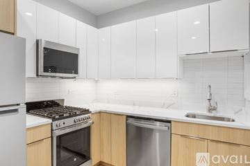 Chicago apartment for rent - A kitchen with white cabinets and a stainless steel dishwasher.