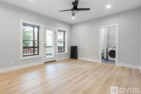 Chicago apartment for rent - A room with a ceiling fan and a washing machine.