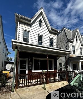 Schuylkill Haven house for rent - A white house with a black car parked in front.