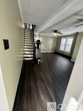 Schuylkill Haven house for rent - A room with a staircase and a ceiling fan.